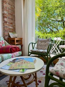 a living room with a table and chairs and a window at Magic Garden - Since 1911 in Luino