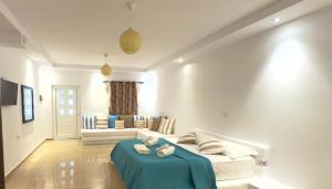 a living room with a couch and a blue table at Rida Village Ksamil Island in Ksamil