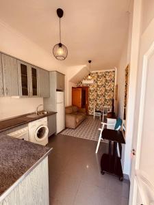 a kitchen with a living room and a dining room at Apartamento Bajondillo Cozy Inns in Torremolinos +8 photos