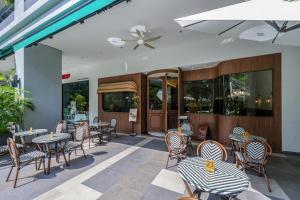 a patio with tables and chairs and a restaurant at Trion Kuala Lumpur by Vivid Stay in Kuala Lumpur