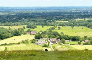 a person sitting on top of a grassy hill at The Stables at The Forge Self Contained Apartment in Pyecombe