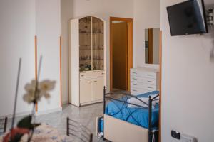 a room with a bedroom with a dresser and a mirror at Residence Riviera in Palinuro