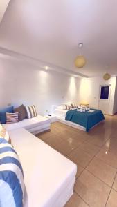 a large room with two beds and a couch at Rida Village Ksamil Island in Ksamil