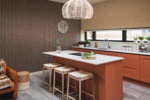 a kitchen with a large island with stools at Horslip in Marlborough +4 photos