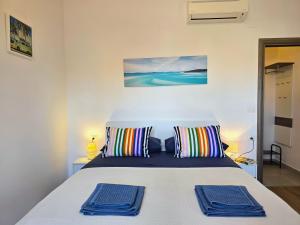 a bedroom with a bed with two pillows on it at Apartments & Rooms Chiara in Rovinj