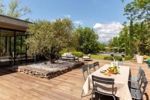 un patio con mesa y sillas y un jardín en Villa Bim, en Bonnieux