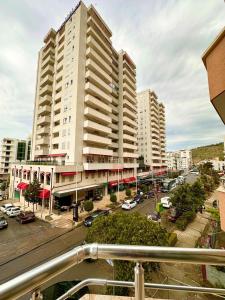 a view of a city with tall buildings and a parking lot at Vila Mare in Shëngjin