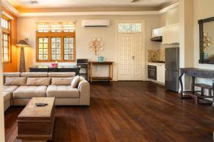 a large living room with a couch and a kitchen at Olma Hotel & Suites in Accra