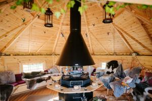 a living room with a stove in a log cabin at Nirvana Glamping in Tiverton