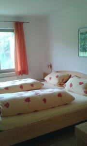 a bedroom with two beds with flowers on them at Ferienwohnung Wiesengrund in Überlingen