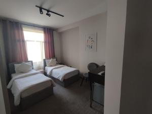 Postel nebo postele na pokoji v ubytování Dastan Hotel Baku