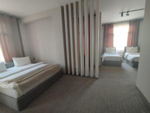 Postel nebo postele na pokoji v ubytování Dastan Hotel Baku