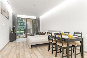 ein Wohnzimmer mit einem Esstisch und einem Bett in der Unterkunft Business Bay Studio Near Dubai Mall, Burj Khalifa & Downtown Hotspots in Dubai