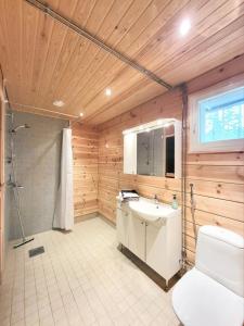 a bathroom with a toilet and a sink and a shower at Vaskooli Apartments in Loimaa +14 photos