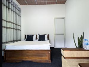 a bedroom with a bed and a window at Crystal Water Inn in Bibile +37 photos