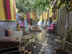 a room with couches and trees in a building at Mandalahome in Marrakesh