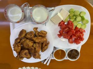 a tray of food with two plates of food at Garden Yard in Berat +21 photos