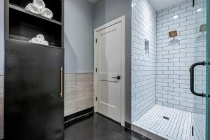 a bathroom with a shower with a black door at Modern Suite 6BR by Maddox Hotel in Nashville