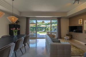 a living room with a couch and a table at Casa Estelle - cozy with lovely garden - Mijas - Riviera del Sol in Mijas Costa