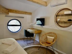 a room with a bed and a desk and a mirror at Les Calanques - Mas des Sous-Bois in Ventabren