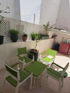 a group of green chairs and a table and chairs at Central Tangier , 3xBedroom , Apartment, Historic Medina, Margarita in Tangier