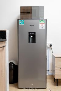 a refrigerator with a water dispenser in a kitchen at Waiyaki Way Starlight in Rungiri