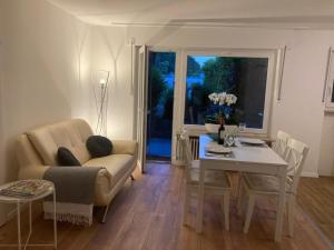 a living room with a couch and a table at Geräumige Wohnung bei Basel in Grenzach-Wyhlen
