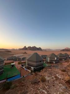 a group of tents in the middle of a desert at Al Raha Luxury Camp in Wadi Rum