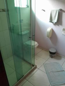 a bathroom with a glass shower and a toilet at Hotel Europa de Itaguaí LTDA in Itaguaí +5 photos