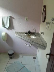 a bathroom with a sink and a toilet at Hotel Europa de Itaguaí LTDA in Itaguaí