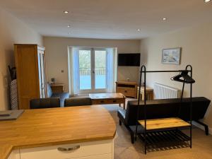 a living room with a couch and a table at Modern, sleeps 5, parking, semi rural, Upholland in Upholland