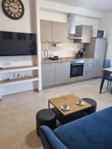 a living room with a blue couch and a table at Apartment Oliva in Krk
