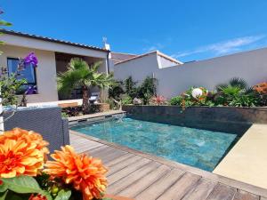 a swimming pool in the backyard of a house at La Chambre Côté Piscine in Aigues-Mortes