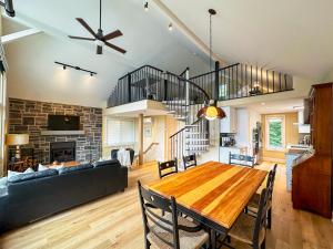 a dining room and living room with a wooden table at Le Mimosa 32 nights min ExitChalets Lake in Morin Heights +39 photos