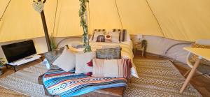 a bedroom with a bed in a tent at Luxury Bell tent Glamping near Yorkshire Wolds in Pocklington