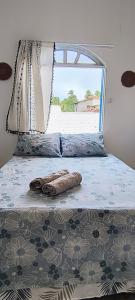 a bedroom with a bed with a view of a beach at Casa Orí Ayô in Vera Cruz de Itaparica
