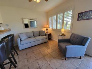 a living room with a couch and a chair at 1 Bed Beach Bungalow #130 in Carpinteria