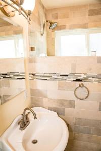 a bathroom with a sink and a mirror at 1 Bed Beach Bungalow #130 in Carpinteria +2 photos