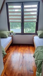 a room with two beds and a large window at Kucica na Dunavu in Smederevo +18 photos