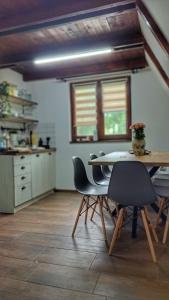 a kitchen with a table and chairs in a room at Kucica na Dunavu in Smederevo