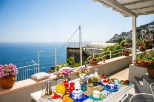 Una mesa en un balcón con vista al mar. en Blue Moon House Praiano, en Praiano