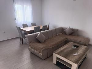 a living room with a couch and a table at Lake View Apartment in Briđe