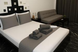 a bedroom with a large bed with towels on it at Κatholikis Room in Kremasti