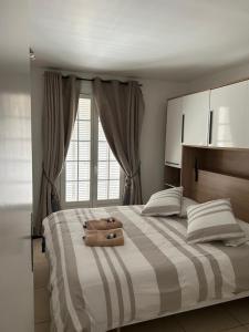 a bedroom with a large bed with a suitcase on it at L'Arche de Porquerolles in Porquerolles
