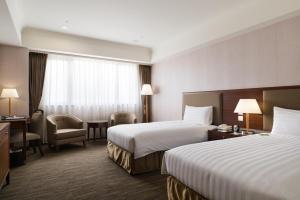 Postel nebo postele na pokoji v ubytování Fushin Hotel Taipei + 37 fotografií