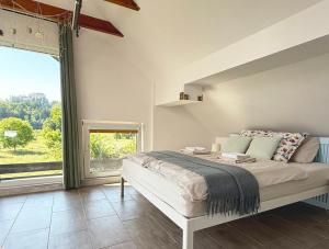 a bedroom with a bed and a large window at Deerwood-Sky Attic with Bled Castle View-NO KITCHEN in Bled