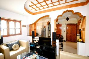 a living room with a couch and a table at Vintage apartment EL JADIDA in El Jadida