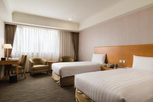 Postel nebo postele na pokoji v ubytování Fushin Hotel Taipei