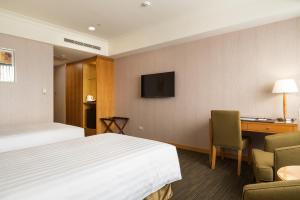 Postel nebo postele na pokoji v ubytování Fushin Hotel Taipei