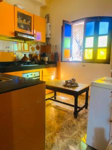 a kitchen with a table in the middle of it at Dar béa in Marrakesh +32 photos
